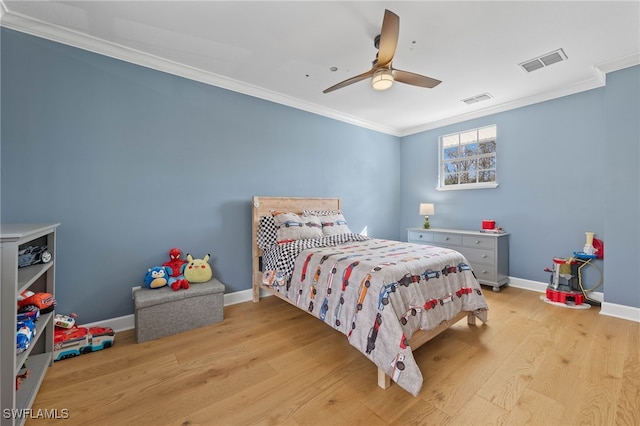bedroom with crown molding, baseboards, wood finished floors, and visible vents