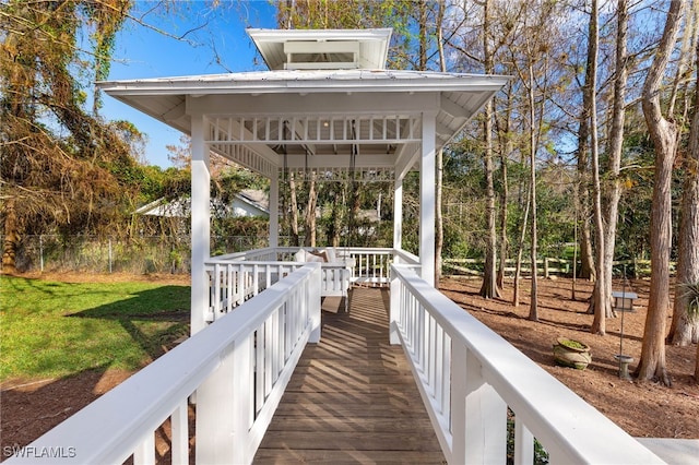 view of community with a lawn, fence, and a gazebo