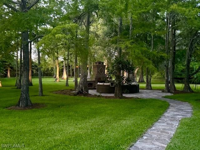 5271 Cherry Wood Dr, Naples, FL 34119 - surrounding community featuring a lawn