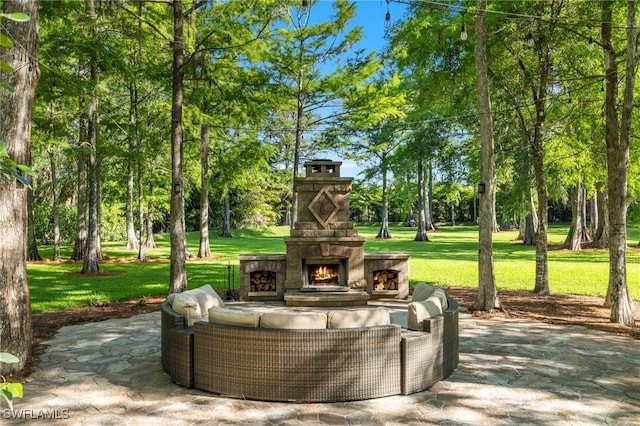 view of patio with an outdoor living space with a fireplace
