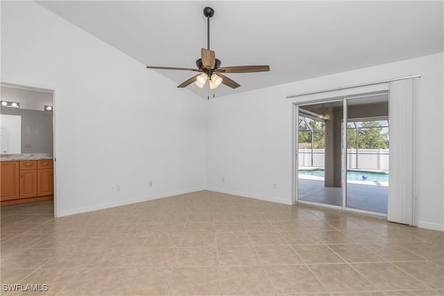 1227 Damen St E, Lehigh Acres, FL 33974 - empty room featuring ceiling fan, baseboards, lofted ceiling, and light tile patterned floors