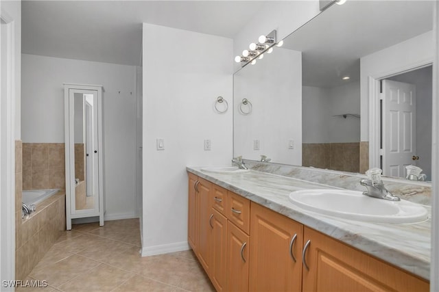 1227 Damen St E, Lehigh Acres, FL 33974 - full bathroom with tile patterned flooring, double vanity, baseboards, and tiled tub