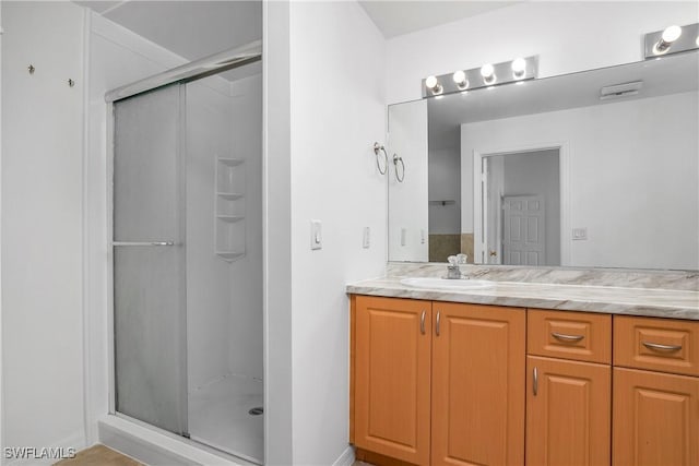 1227 Damen St E, Lehigh Acres, FL 33974 - full bath featuring a stall shower, vanity, and baseboards