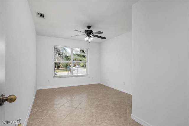 1227 Damen St E, Lehigh Acres, FL 33974 - spare room with ceiling fan, baseboards, and light tile patterned flooring