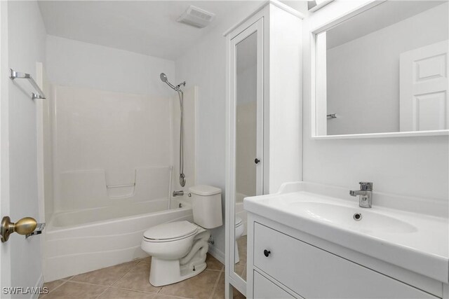 1227 Damen St E, Lehigh Acres, FL 33974 - full bathroom featuring toilet, tile patterned flooring, shower / bathtub combination, and vanity