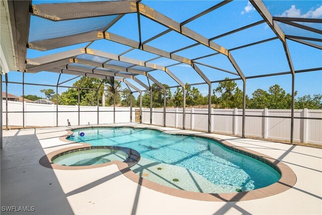 1227 Damen St E, Lehigh Acres, FL 33974 - view of pool with a patio, a pool with connected hot tub, fence, and glass enclosure