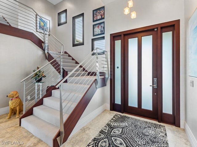 580 Goldcoast Ct, Marco Island, FL 34145 - foyer featuring baseboards, tile patterned floors, and stairway