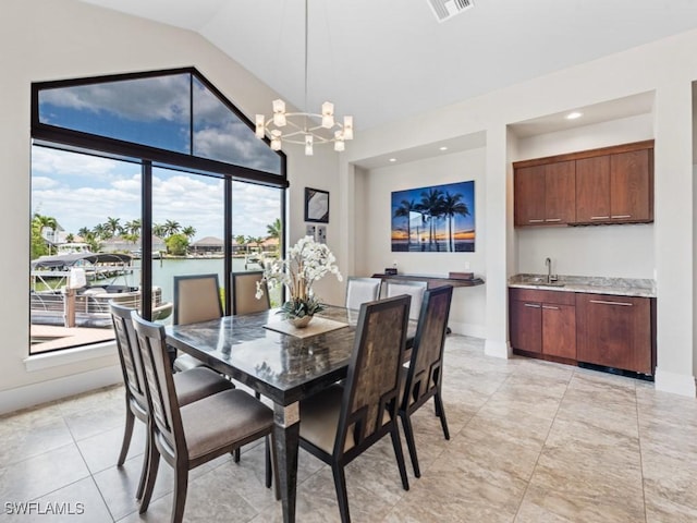 580 Goldcoast Ct, Marco Island, FL 34145 - dining space with an inviting chandelier, baseboards, wet bar, and visible vents