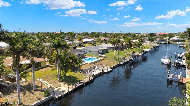 birds eye view of property with a water view and a residential view