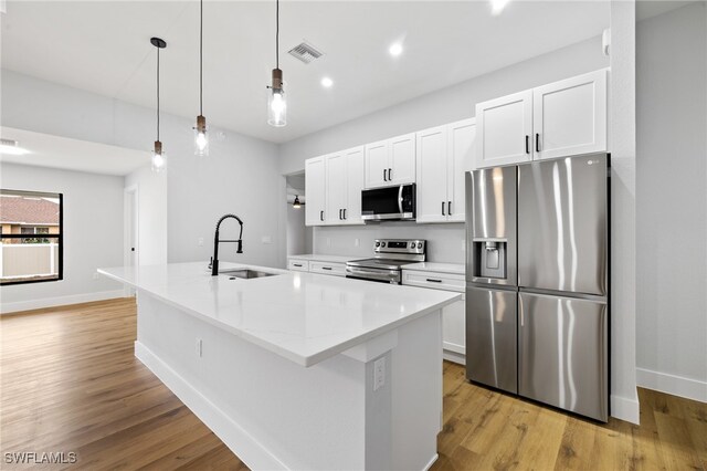 2706 39th St W, Lehigh Acres, FL 33971 - kitchen featuring a sink, a center island with sink, visible vents, white cabinets, and appliances with stainless steel finishes