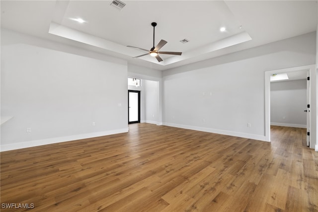 2706 39th St W, Lehigh Acres, FL 33971 - empty room featuring a ceiling fan, visible vents, a raised ceiling, and light wood-style floors