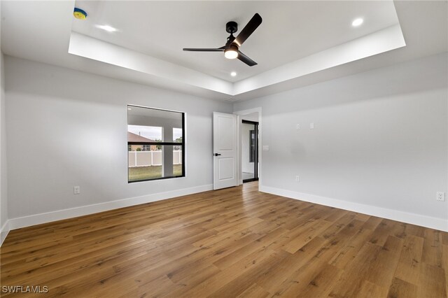 2706 39th St W, Lehigh Acres, FL 33971 - spare room featuring recessed lighting, a tray ceiling, a ceiling fan, baseboards, and wood finished floors