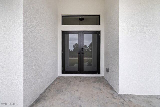 2706 39th St W, Lehigh Acres, FL 33971 - doorway to property featuring stucco siding and french doors