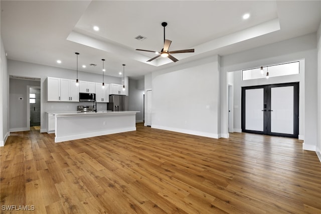 2706 39th St W, Lehigh Acres, FL 33971 - unfurnished living room with visible vents, recessed lighting, and a tray ceiling