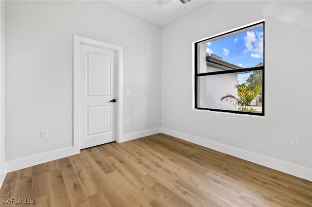 2706 39th St W, Lehigh Acres, FL 33971 - spare room featuring wood finished floors and baseboards