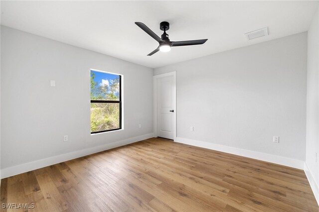 2706 39th St W, Lehigh Acres, FL 33971 - empty room with a ceiling fan, visible vents, light wood-style floors, and baseboards