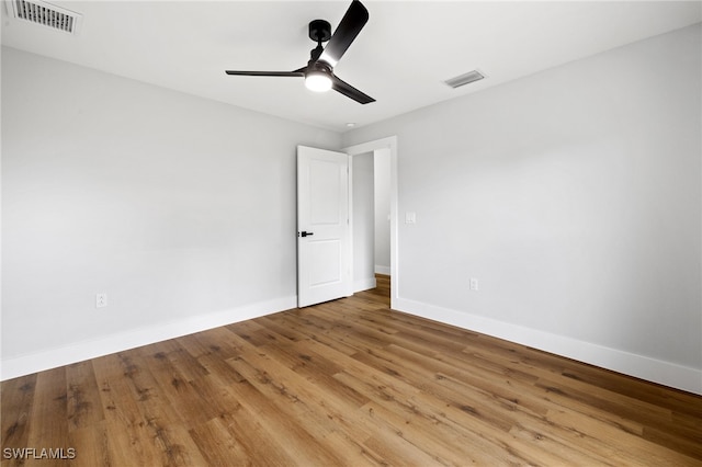 2706 39th St W, Lehigh Acres, FL 33971 - empty room with visible vents, wood finished floors, and baseboards