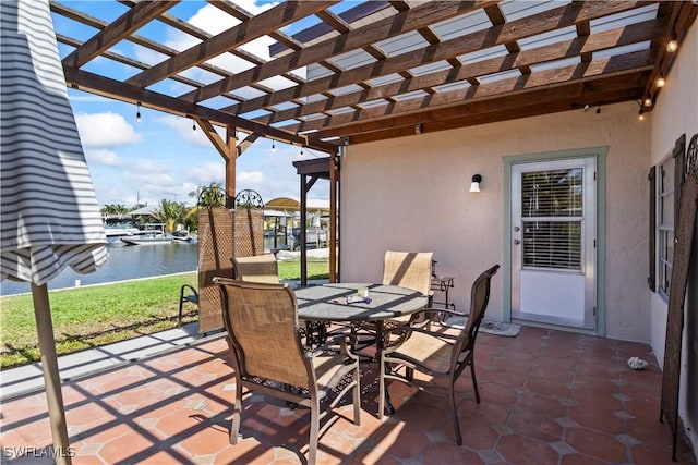 view of patio featuring a pergola, a water view, and outdoor dining space