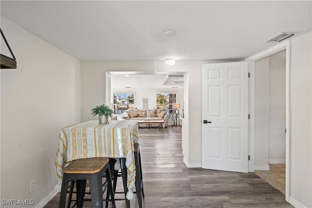 dining space featuring baseboards, dark wood-style flooring, and visible vents