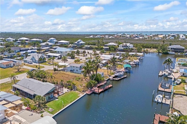 bird's eye view featuring a water view and a residential view