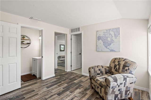 sitting room with visible vents, baseboards, and dark wood-style floors