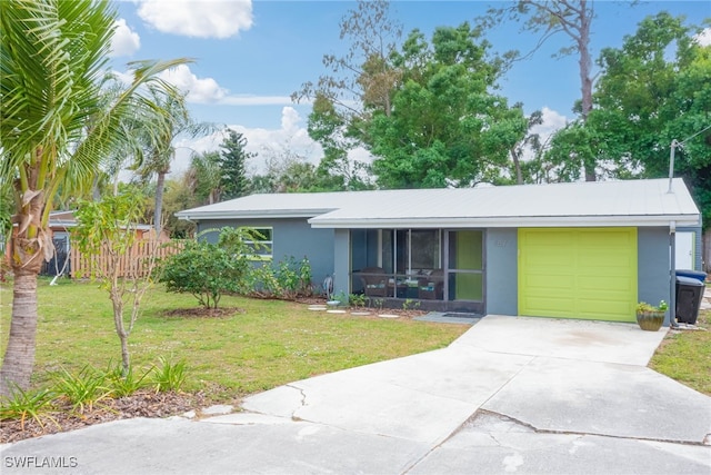single story home featuring stucco siding, fence, driveway, a front lawn, and an attached garage