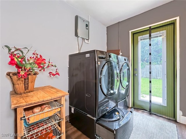 laundry area with separate washer and dryer, dark wood-style floors, and laundry area