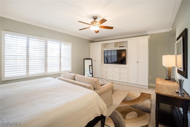 bedroom featuring a ceiling fan, ornamental molding, and light carpet