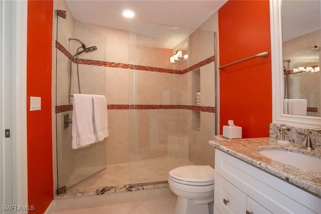 full bath featuring tile patterned floors, a shower stall, toilet, and vanity