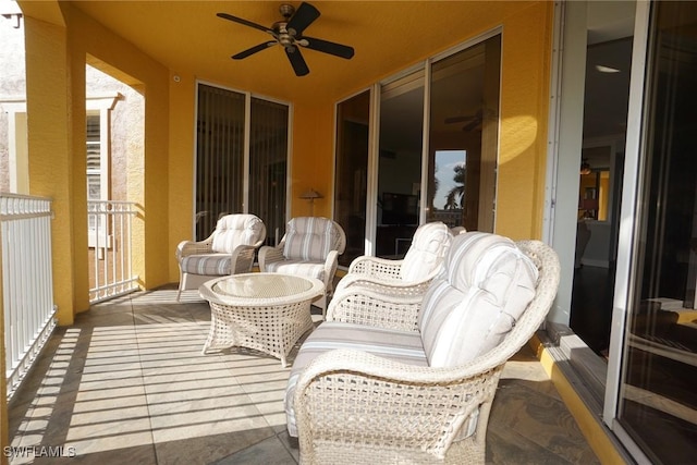 exterior space featuring a ceiling fan and a balcony