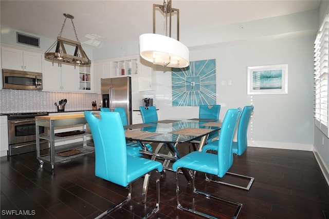 dining room with dark wood-style floors, visible vents, and baseboards