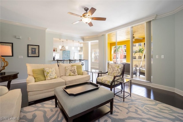 living room with ceiling fan, ornamental molding, dark wood-style floors, and baseboards