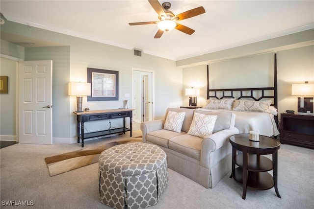 carpeted bedroom with visible vents, ornamental molding, and baseboards