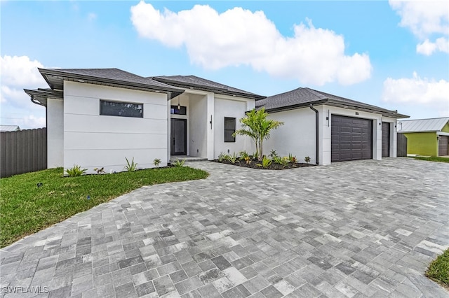 806 Santa Barbara Blvd, Cape Coral, FL 33991 - prairie-style home with stucco siding, decorative driveway, fence, and a garage