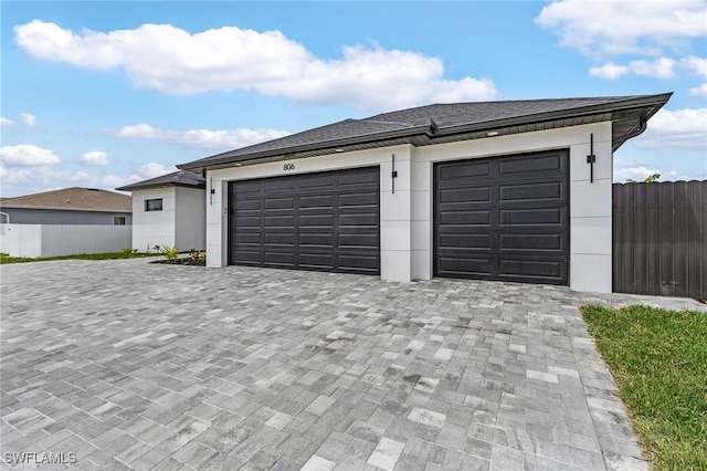 806 Santa Barbara Blvd, Cape Coral, FL 33991 - garage featuring fence and decorative driveway