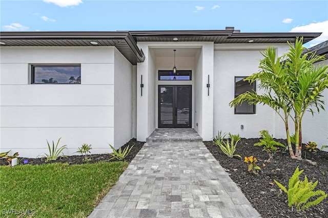806 Santa Barbara Blvd, Cape Coral, FL 33991 - property entrance with stucco siding and french doors