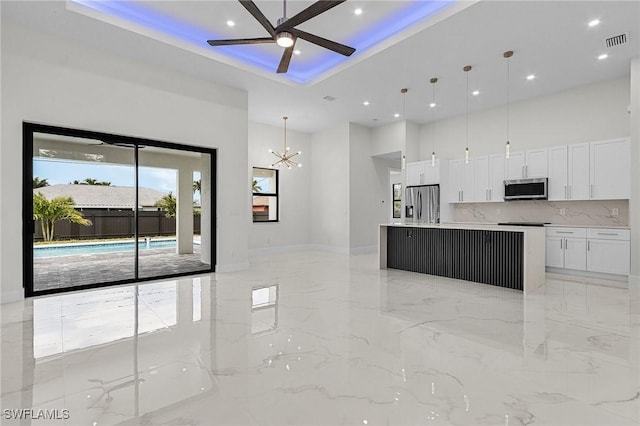 806 Santa Barbara Blvd, Cape Coral, FL 33991 - kitchen with appliances with stainless steel finishes, marble finish floor, ceiling fan with notable chandelier, visible vents, and a high ceiling