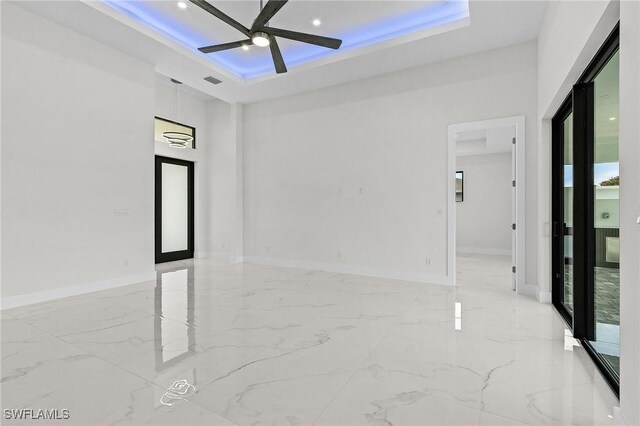 806 Santa Barbara Blvd, Cape Coral, FL 33991 - spare room featuring a raised ceiling, ceiling fan, and marble finish floor