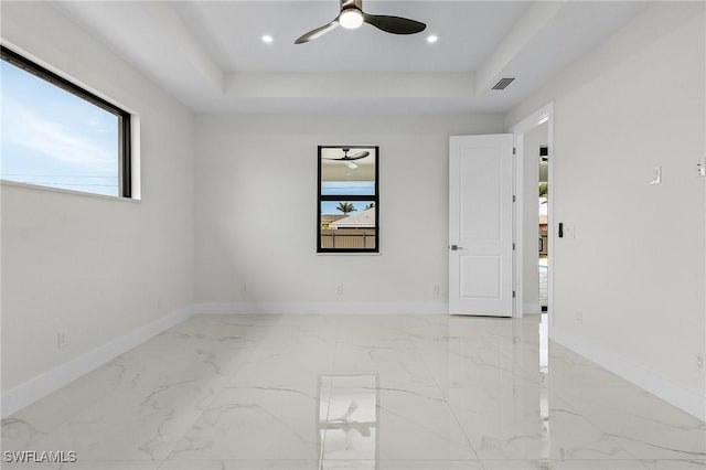 806 Santa Barbara Blvd, Cape Coral, FL 33991 - spare room with marble finish floor, ceiling fan, a raised ceiling, and visible vents