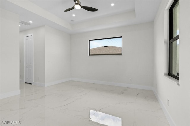 806 Santa Barbara Blvd, Cape Coral, FL 33991 - unfurnished room featuring recessed lighting, marble finish floor, ceiling fan, baseboards, and a tray ceiling