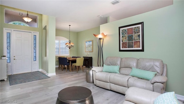 761 Grand Rapids Blvd, Naples, FL 34120 - living area with a chandelier, light wood-style flooring, and baseboards