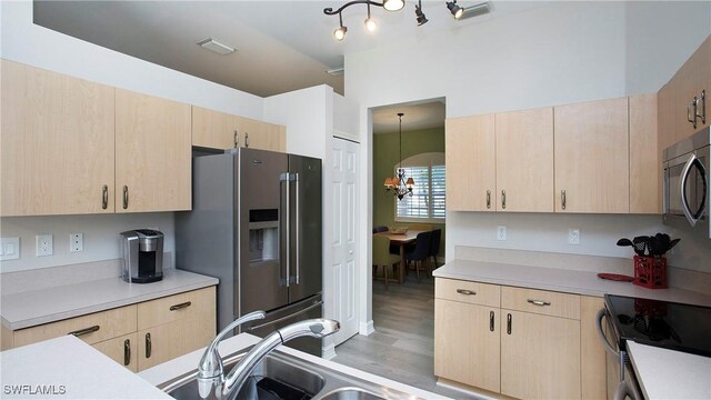 761 Grand Rapids Blvd, Naples, FL 34120 - kitchen with light brown cabinetry, appliances with stainless steel finishes, light countertops, and light wood-type flooring