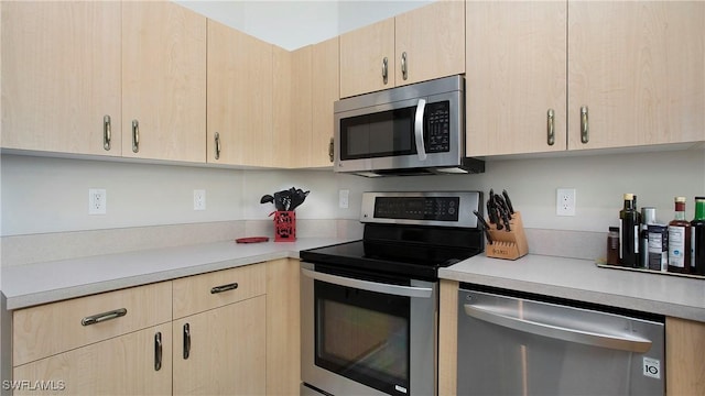 761 Grand Rapids Blvd, Naples, FL 34120 - kitchen with appliances with stainless steel finishes, light brown cabinets, and light countertops
