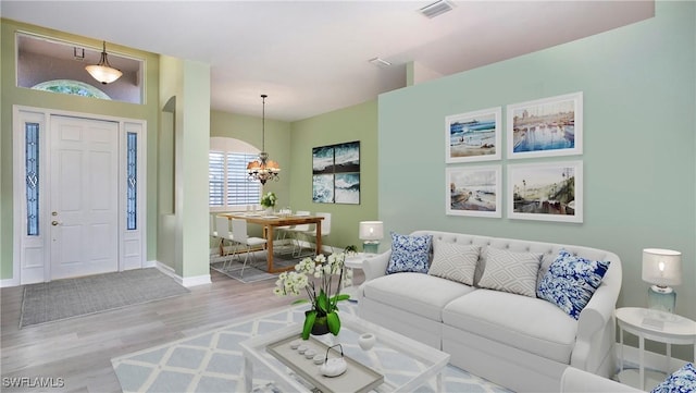 761 Grand Rapids Blvd, Naples, FL 34120 - living area with a chandelier and wood finished floors