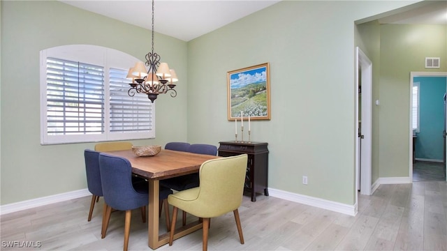 761 Grand Rapids Blvd, Naples, FL 34120 - dining area featuring a chandelier, light wood-style floors, and baseboards