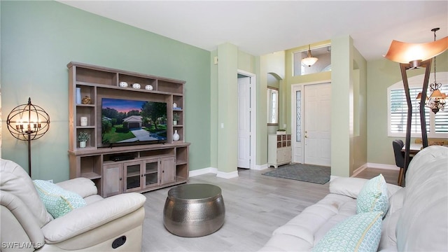 761 Grand Rapids Blvd, Naples, FL 34120 - living room featuring wood finished floors, a chandelier, and baseboards