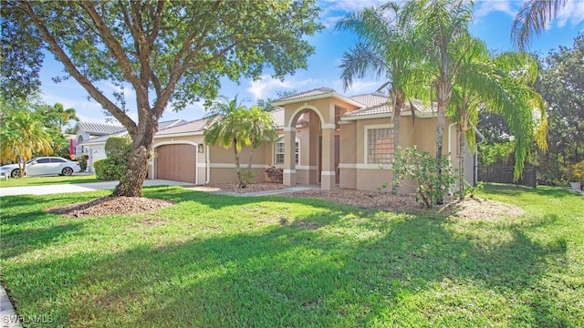 761 Grand Rapids Blvd, Naples, FL 34120 - mediterranean / spanish-style house with stucco siding, a garage, concrete driveway, and a front yard