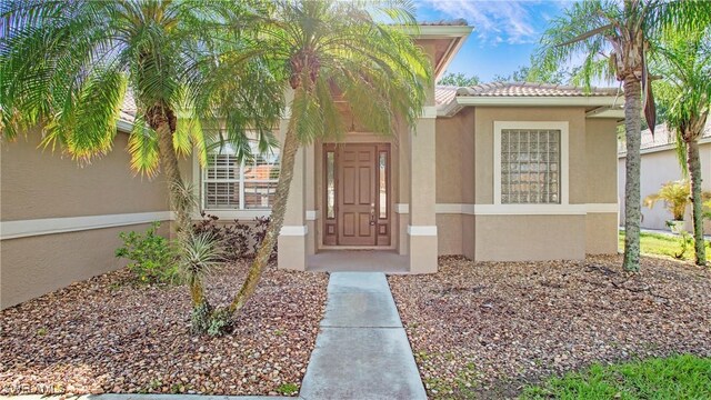 761 Grand Rapids Blvd, Naples, FL 34120 - entrance to property with stucco siding and a tiled roof