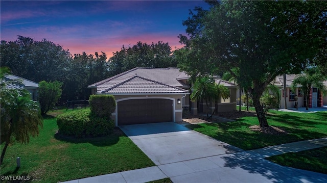 761 Grand Rapids Blvd, Naples, FL 34120 - mediterranean / spanish house with a garage, a tiled roof, stucco siding, and a yard