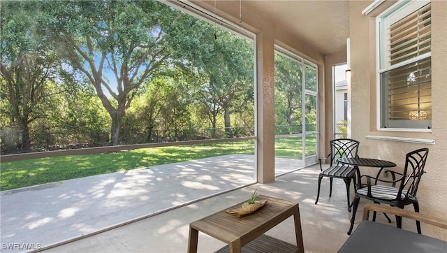 761 Grand Rapids Blvd, Naples, FL 34120 - sunroom with a textured wall and view of scattered trees
